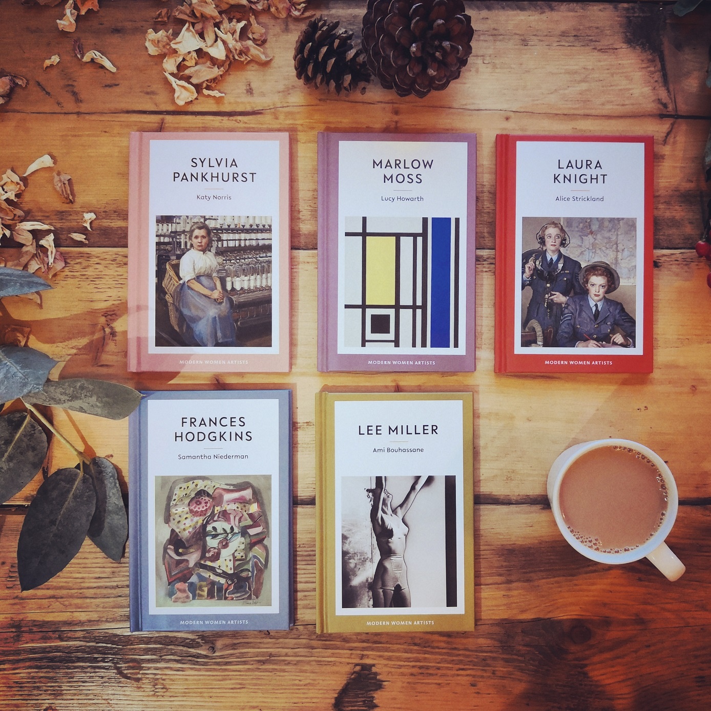 Eiderdown Press books Photograph of the range of five Eiderdown Press books on a wooden floor next to a cup of tea.